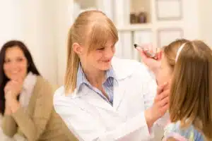 female pediatrician doing eye check up to little girl SBI 300904375 1920w